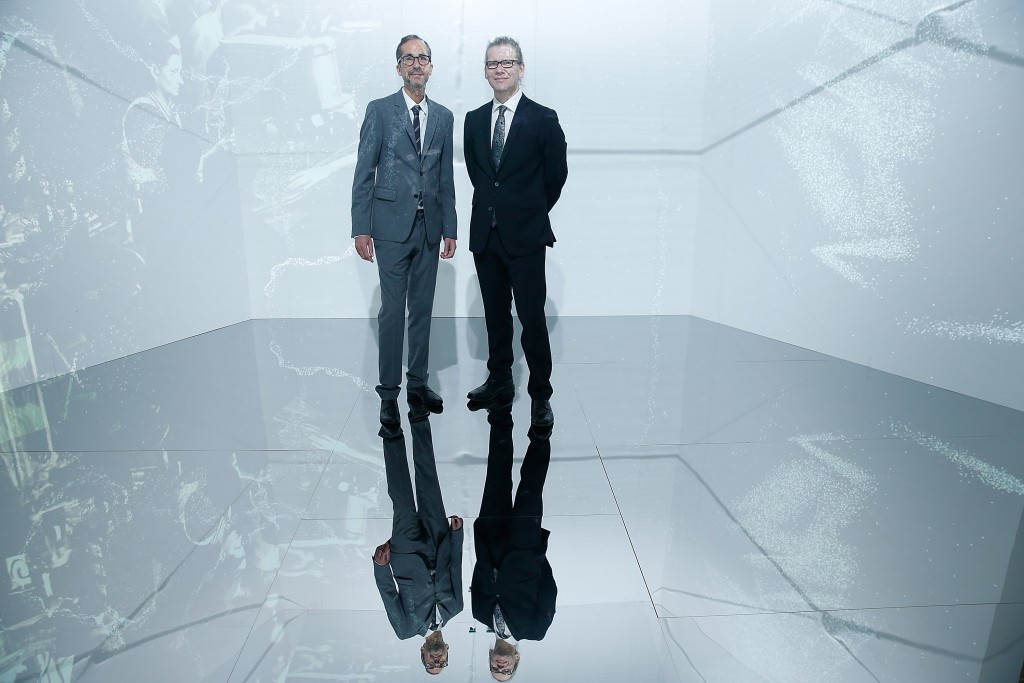 Herve Mikaeloff and the artist Charles Sandison pose in hin art installation